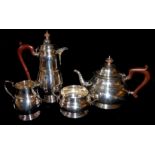 A VINTAGE GEORGIAN STYLE FOUR PIECE SILVER TEA SERVICE Comprising a teapot, hot water jug, sugar