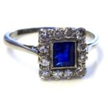 A PLATINUM, DIAMOND AND PRINCESS CUT SAPPHIRE RING (size N/O).