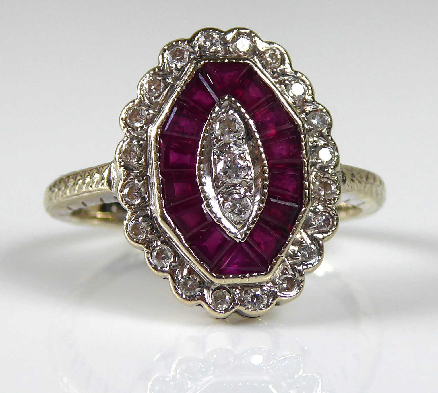 AN ART DECO 18CT GOLD, RUBY AND DIAMOND RING Set with a single row of diamonds edged by rubies - Image 2 of 2