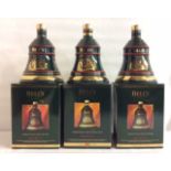 WADE, THREE VINTAGE SEALED POTTERY BELLS WHISKEY DECANTERS To include 70cl decanters dated Christmas