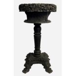 A REGENCY PERIOD COLONIAL EBONY JARDINIÈRE Heavily carved with flowers, raised on an acanthus carved