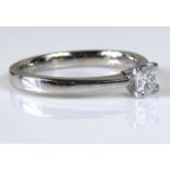 AN 18CT WHITE GOLD AND DIAMOND SOLITAIRE RING Set with a Princess cut stone held in a raised