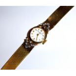 VACHERON & CONSTANTIN, A VINTAGE 18CT GOLD BRACELET WATCH With diamond encrusted shoulders. (18.5cm)