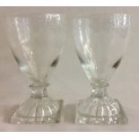 A PAIR OF 18TH CENTURY CONICAL RUMMER GLASSES WITH LEMON SQUEEZER BASES The bowls etched with swags,