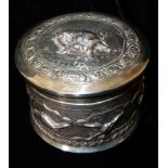 AN EARLY 20TH CENTURY CYLINDRICAL INDIAN SILVER TRINKET BOX With an embossed continuous scene,