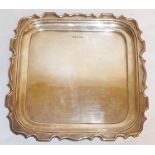 WALKER & HALL, A 1920'S SILVER TRAY With shaped edge, raised on downswept feet. (h 4cm x w 28cm x