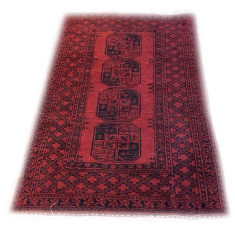 A VINTAGE AFGHAN RUG Red ground with four octagonal panels to central field. (approx 113cm x 173cm)