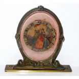 AN EARLY 20TH CENTURY GILT BRONZE SCROLLED OVAL MANTLE CLOCK With enamelled figural dial, marked '