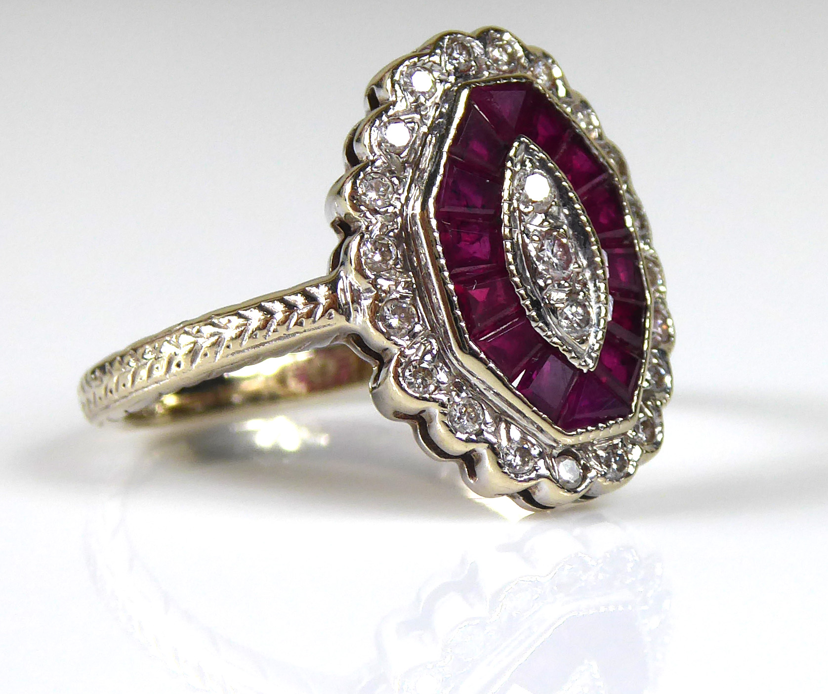 AN ART DECO 18CT GOLD, RUBY AND DIAMOND RING Set with a single row of diamonds edged by rubies