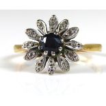 AN 18CT GOLD, DIAMOND AND SAPPHIRE DAISY CLUSTER RING With single round cut sapphire flanked by
