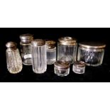 A COLLECTION OF EIGHT EDWARDIAN SILVER AND CUT GLASS TRINKET BOTTLES Each with different engraved