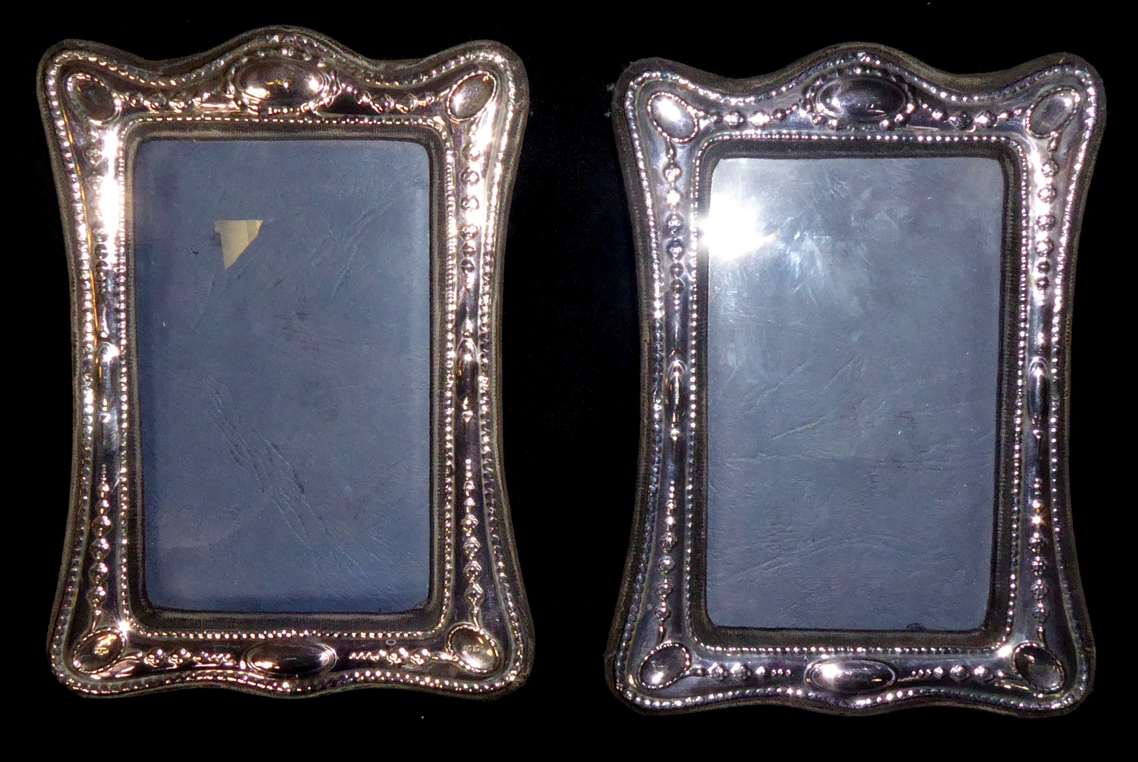 A PAIR OF 20TH CENTURY SILVER RECTANGULAR EASLE PHOTOGRAPH FRAMES With embossed decoration,