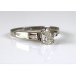 AN 18CT WHITE GOLD AND DIAMOND SOLITAIRE RING Having a pear cut diamond set between two tapering