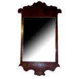 A GEORGIAN WALNUT FRETWORK MIRROR With a scrolled frame. (approx 41cm x 58cm)