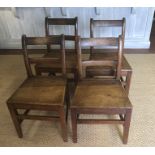 A SET OF FOUR GEORGIAN ELM COUNTRY DINING CHAIRS With bar backs and solid seats.