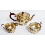 AN EDWARDIAN SILVER THREE PIECE TEA SET Comprising a teapot, cream jug and sugar basin, all with