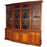 MAPLES & CO., A LATE 19TH CENTURY GEORGE III DESIGN MAHOGANY BREAKFRONT BOOKCASE The four astragal