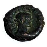 A ROMAN BRONZE COIN With an embossed portrait of an Emperor and a standing figure to reverse. (