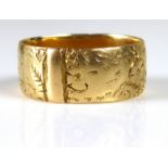 A VINTAGE 18CT GOLD WEDDING BAND Finely engraved with floral scrolls (size M).