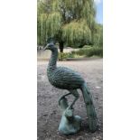 A GREEN PATINATED BRONZE STATUE OF A PEACOCK. (89cm)