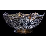 JOSEPH ROUND, AN EARLY 20TH CENTURY SILVER BOWL With pierced floral motifs raised on a gadrooned