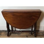 A VICTORIAN MAHOGANY SUTHERLAND TABLE With turned stretcher and legs standing on brass castors. (