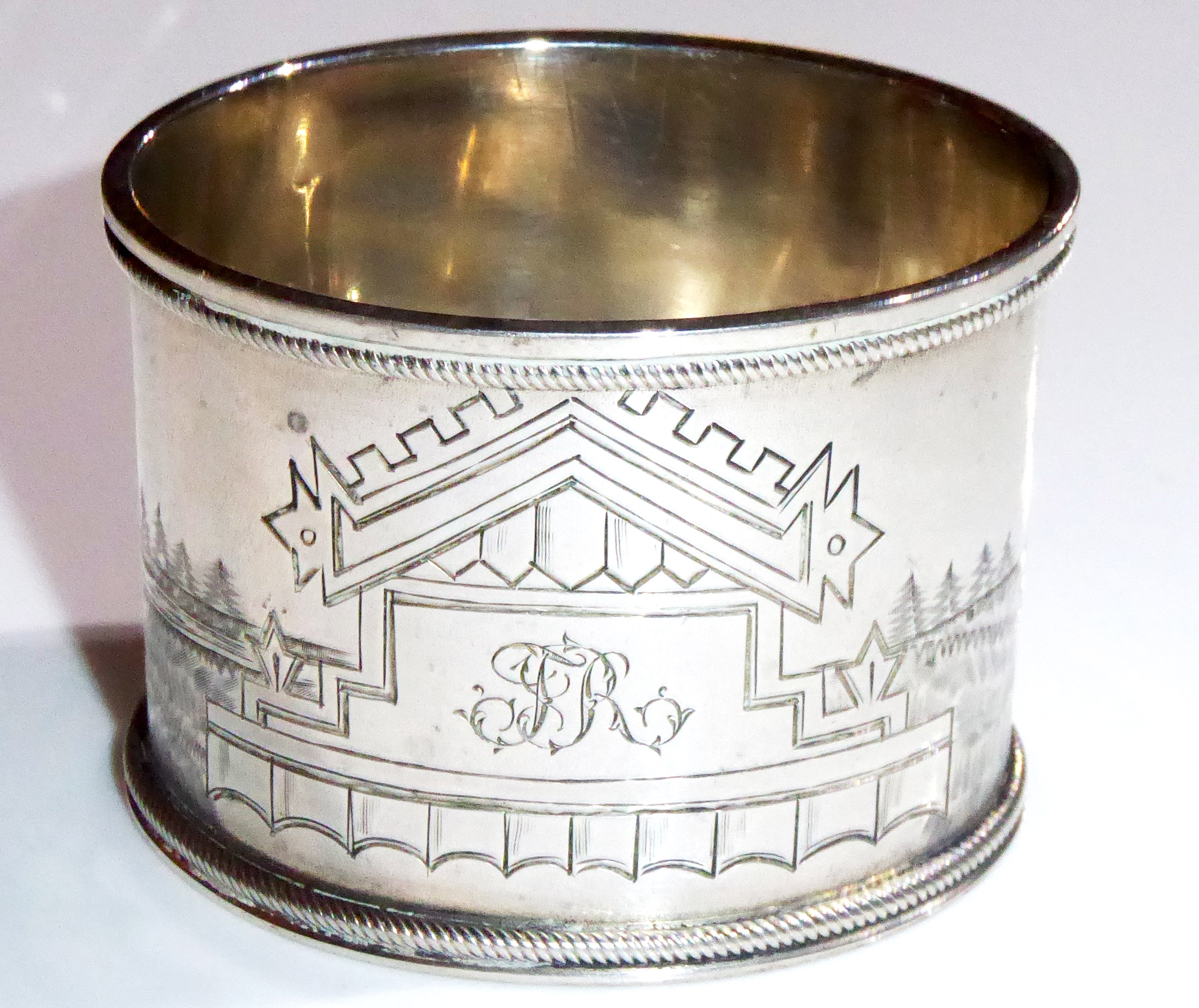 A 19TH CENTURY RUSSIAN SILVER OVAL SERVIETTE RING Finely engraved with Cossacks and horse drawn