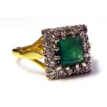 A VINTAGE 9CT GOLD, EMERALD AND DIAMOND RING Having a square cut emerald edged in diamonds (size M).