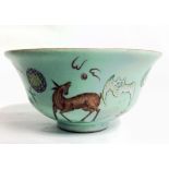 A CHINESE CELADON GLAZED BOWL Having a flared rim and hand painted with dragons and bats, bearing