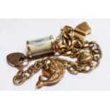 A VINTAGE 9CT GOLD CHARM BRACELET Set with five charms including an old one pound note, a fish and