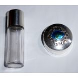 AN EARLY 20TH CENTURY SILVER PILL BOX The lid with stylized scroll motif and enamelled decoration,