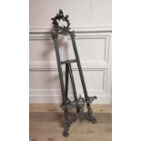 A LARGE LATE 19TH/ EARLY 20TH CENTURY BRASS EASEL/STAND Tapering shape with Rococo style scrolls,