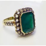 A LARGE ART DECO GOLD, EMERALD AND DIAMOND RING Surrounded by diamonds flanked by diamond