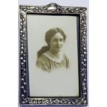 AN EDWARDIAN SILVER RECTANGULAR EASLE PHOTOGRAPH FRAME Embossed with floral decoration, hallmarked