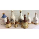 WADE, A COLLECTION OF EIGHT VINTAGE SEALED POTTERY BELLS WHISKEY DECANTERS Commemorating the 19th