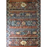 A KILIM WOOLEN RUG Hand woven with bands of geometric designs on burnt orange ground. (approx