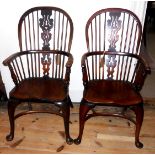 A MATCHED PAIR OF EARLY 19TH CENTURY WINDSOR OPEN ARMCHAIRS Yew and elm and ash and elm, raised on