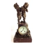 A 19TH CENTURY MARBLE AND SPELTER FIGURAL MANTLE CLOCK Two classical style putti and an