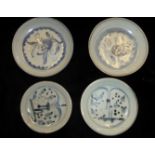 A COLLECTION OF FOUR CHINESE MING DYNASTY PORCELAIN PLATES Hand painted with stylized blue and white