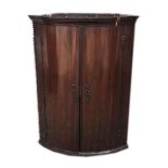 A GEORGE III PERIOD MAHOGANY BOW FRONTED CORNER CABINET. (74cm x 99cm x 57cm)
