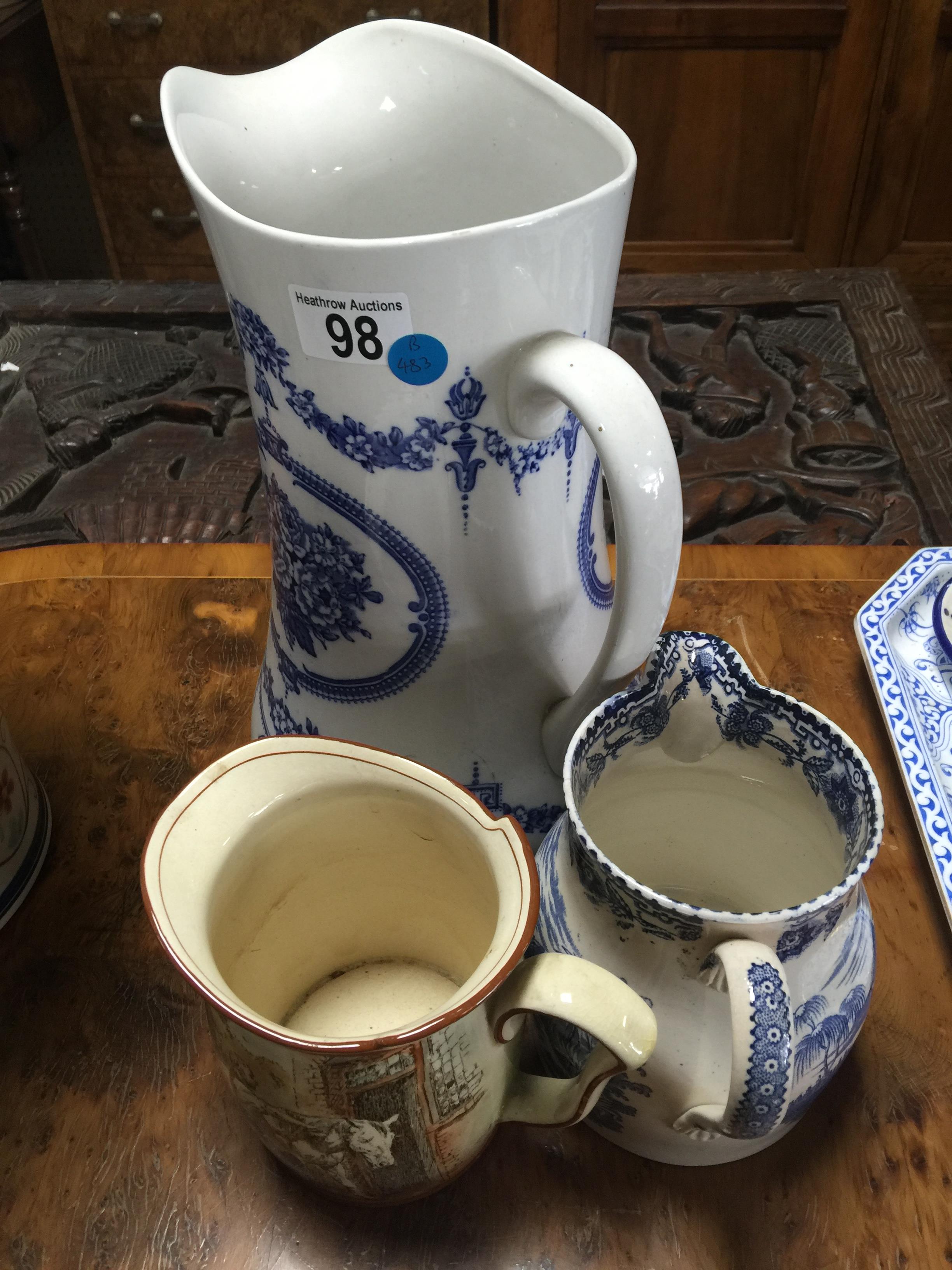 3 ASSORTED JUGS . 2 BLUE AND WHITE CERAMIC JUGS AND 1 SMALL ROYAL DAULTON