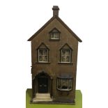 A LATE 19TH/EARLY 20TH CENTURY WOODEN DOLLS HOUSE Spread over three floors with steps to door with