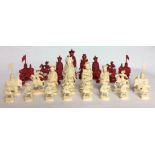 A 19TH CENTURY CHINESE NATURAL AND STAINED IVORY THIRTY-TWO PIECE CHESS SET Kings and Queens as