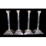 A SET OF FOUR GEORGIAN SILVER CLASSICAL CANDLESTICKS Supported on architectural columns with