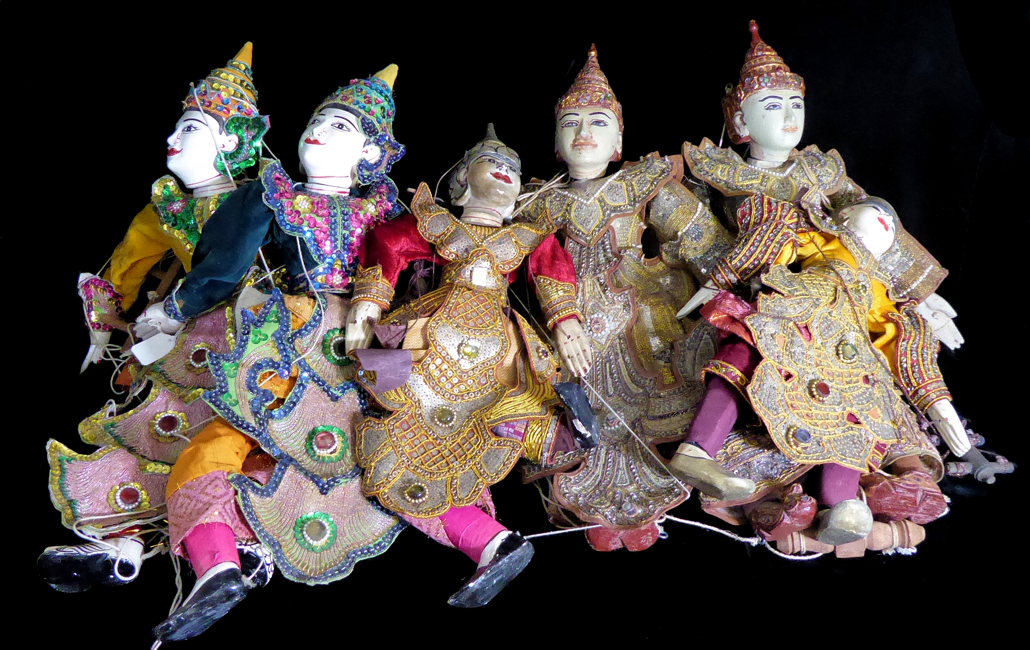 SIX EARLY 20TH CENTURY THAI PUPPETS With hand painted facial features and embroidered clothes