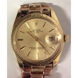 ROLEX, OYSTER PERPETUAL, A GENT'S 18CT GOLD DATE WRISTWATCH Having a gold tone dial with calendar