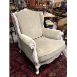 FRENCH ANTIQUE UPHOLSTERED IN FAWN HAND CARVED LOUIS STYLE ARMCHAIR WITH SCROLL END ARMS AND