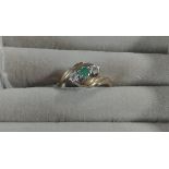 L EMERALD AND DIAMOND 9CT CROSSOVER RING