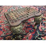 VICTORIAN CAST IRON FIRE STAND WITH PIERCED QUATRIFOILS TOP SITTING ON DECORATIVE CLAW AND BALL FEET