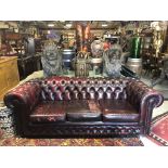 RED CHESTERFIELD STYLE THREE SEATER SOFA TWO TEARS IN TWO OF THE CUSHIONS H X 71 D X 87 W X 200